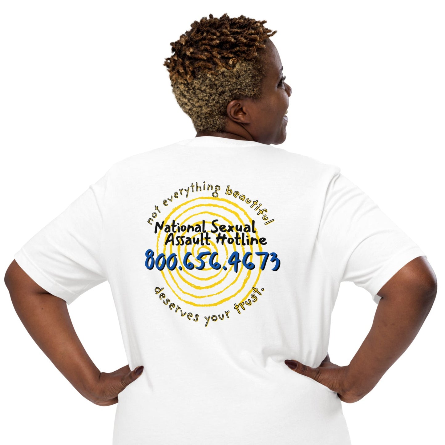 Plus-size model wearing Not Everything Beautiful t-shirt back view with hotline and symbolic spiral artwork.